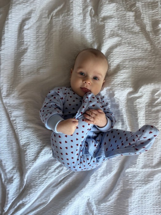 Blauer Baby-Strampler mit Herzchen und umklappbaren Ärmeln