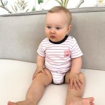 Weißer Babybody mit roten Streifen und rosa Aufnäher